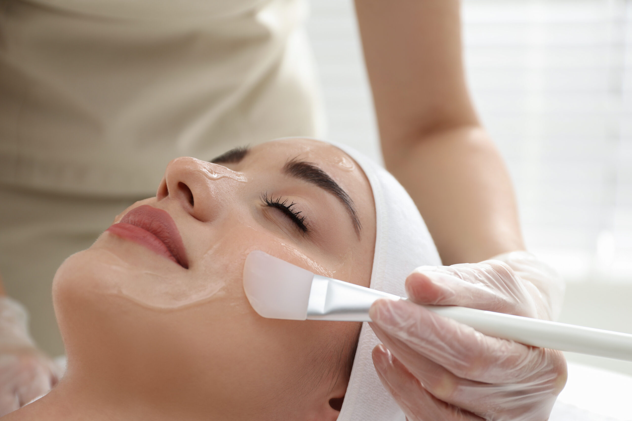 Young woman during face peeling procedure in salon Young woman during face peeling procedure in salon